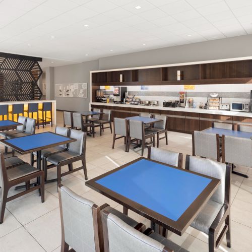 Breakfast room with dining tables and buffet counters.