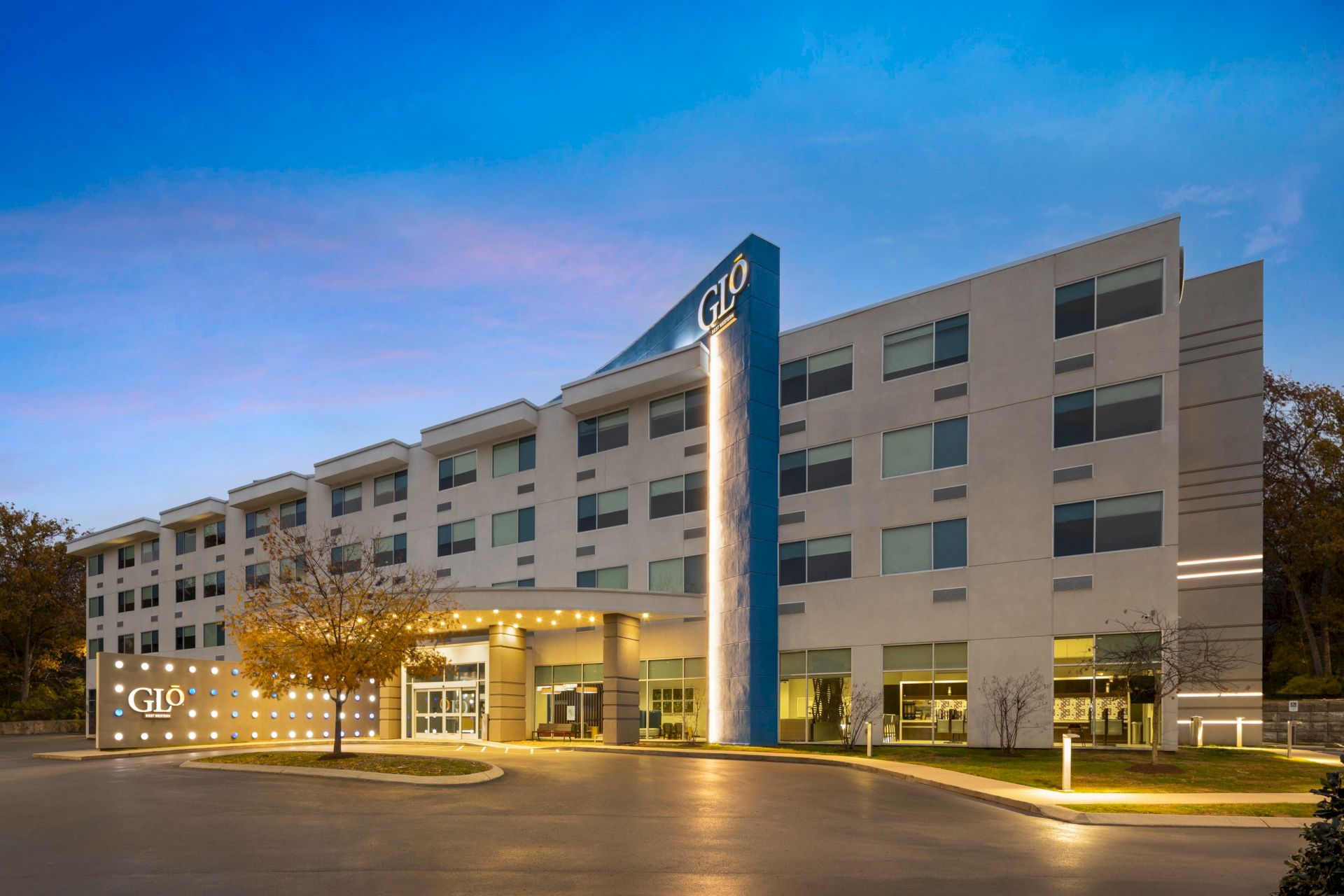 GLō Best Western Nashville Airport exterior at dusk.